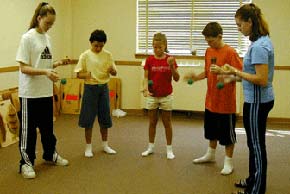 A group of students passing bean bags in rhythm