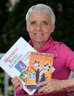Cecilia "Cece" Koester Osborne holding her books Movement Based Learning and I Am the Child