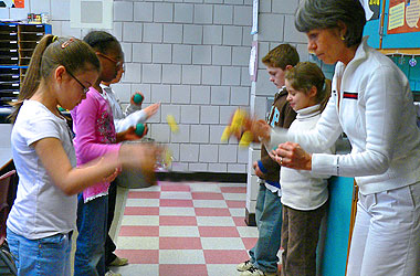 Students doing bean-bag rhythm exercises with Candi