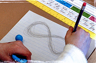 A hand tracing the Bal-A-Vis-X figure-eight pattern